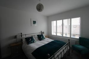 班戈北爱尔兰SEACLIFF ROAD APARTMENT的卧室配有床、椅子和窗户。