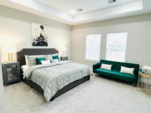 休斯顿Upcoming Houston Down 3 Bedroom brand new listing的一间卧室配有一张床和一张绿色沙发