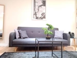 科隆Apartment - Neu, modern, gemütlich, eigener Parkplatz的客厅配有蓝色的沙发和桌子