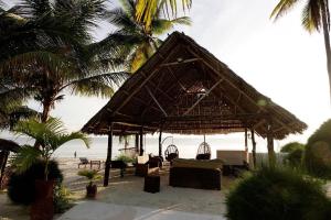 乌罗阿乌罗阿月光精品酒店的海滩上的小屋,配有椅子和棕榈树