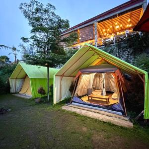 KejajarBagas Luxury Camp的两个帐篷在晚上在大楼前
