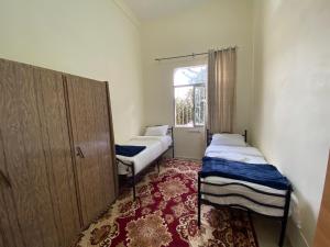 纳布卢斯Hayat Guest House的小房间设有两张床和窗户