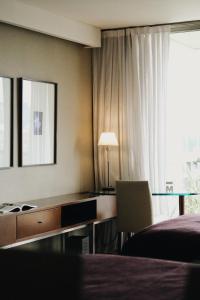 布宜诺斯艾利斯马德罗布宜诺斯艾利斯酒店的酒店客房设有一张桌子、一张床和一个窗户。