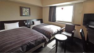 鲁特酒店-彦根旅馆客房内的一张或多张床位