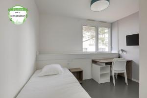 波尔多All Suites Bordeaux Marne – Gare Saint-Jean的一间卧室配有一张床、一张书桌和一个窗户。