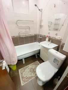 阿拉木图Apartments Ahmetova 6 32的浴室配有卫生间、浴缸和水槽。