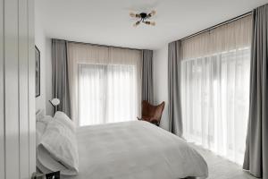 伯明翰OneFiveSix - Unique Apartments的卧室配有白色的床和2扇窗户。