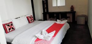 卡图纳耶克KINGS GATE Airport TRANSIT HOTEL的卧室配有白色床和红白毯子