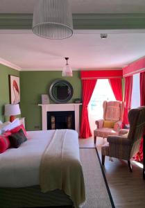 Tummel BridgeThe Inn at Loch Tummel的一间卧室配有一张床、一把椅子和一个壁炉