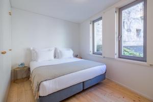 波尔图YOUROPO - Taipas的一间卧室设有一张大床和两个窗户。