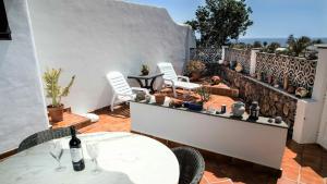 查德尔帕罗奥Casa CHARCO 5的庭院配有白色桌椅和围栏