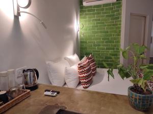 斋浦尔Mukam, Boutique Homestay的两个枕头坐在一个绿砖墙的柜台上