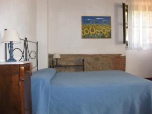 里奥托尔托布罗兹瓦乐农家乐的卧室配有蓝色的床和墙上的绘画作品
