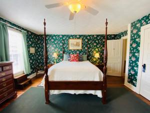 BurnsvilleTerrell House B&B的一间卧室配有一张带绿色花卉壁纸的床