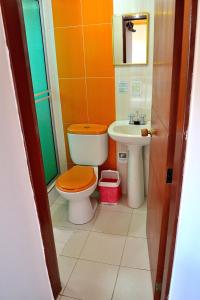 伊萨Hotel Itzamana的橙色浴室设有卫生间和水槽