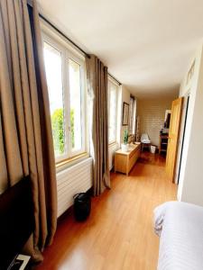 多维尔Villa Bon Accueil的客房设有床和大窗户。