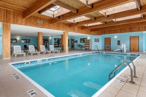 大布兰克Comfort Inn & Suites的一座带椅子和桌子的酒店游泳池