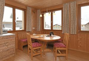 布雷根茨沃尔德地区奥Schmiedlarhof的厨房配有木桌、椅子和窗户。