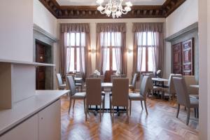 威尼斯Hotel Palazzo Martinelli Dolfin的一间带桌椅的用餐室