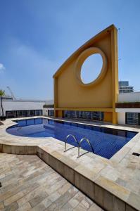 圣保罗Slaviero São Paulo Ibirapuera的一座游泳池,在大楼内设有一个圆形窗户