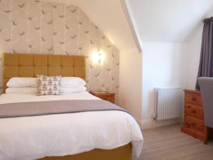 兰迪德诺克里夫布里旅馆的一间卧室配有一张大床和大床头板
