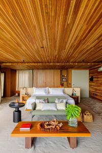 泰巴Carmel Taíba Exclusive Resort的一间卧室设有一张大床和木制天花板