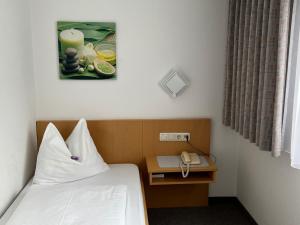 KlausHotel-Pension Sternen的酒店客房配有一张床和电话