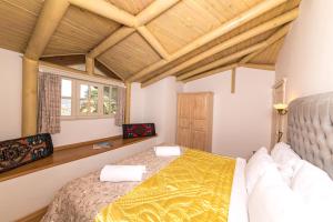马尔马里斯佩图亚康纳克精品酒店的一间卧室设有一张床和木制天花板