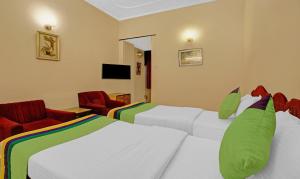 加尔各答Treebo Trend Mira Inn的酒店客房,配有两张床和两把椅子
