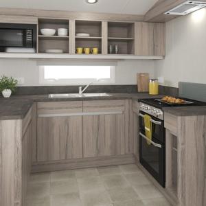 阿伯劳尔The Trout Van - Beautiful, luxury static caravan的厨房配有木制橱柜和炉灶烤箱。