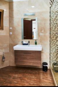 库马西ROYAL BASIN RESORT的一间带水槽和镜子的浴室