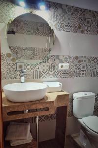 扎霍拉Hacienda Sajorami的一间带水槽、卫生间和镜子的浴室