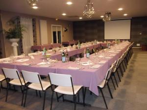 阿普瓦尼基里亚德奥克斯尔阿伯尼酒店的长宴会桌,带紫色的桌布和椅子