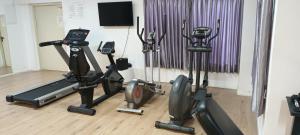 亚实基伦Private Jacuzzi Garden Beach Suite, Gym, 3 Min Walk To Beach דירת גקוזי ספא גינה ענקית 3 דקות הליכה לים וחדר כושר的健身房设有3台跑步机和健身自行车