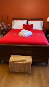 L'islet Sur MerGîte du Pionnier的一张带红色毯子的床和两张毛巾