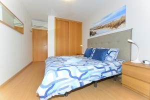 波尔蒂芒Varandas D'Agua的一间卧室配有一张带蓝色和白色棉被的床