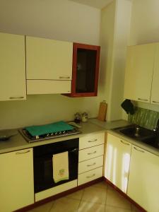 Funtana MeigaMonolocale a 200 metri dal mare的厨房配有白色橱柜和黑烤箱。