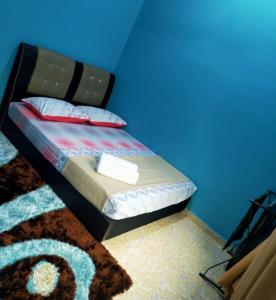 Kampung RajaTeratak Ammara Homestay Besut with private pool的一间卧室配有一张蓝色墙壁的床