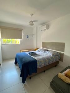 阿拉亚尔-杜卡布APARTAMENTO EM ARRAIAL DO CABO - RJ的一间卧室配有一张带蓝色毯子的床