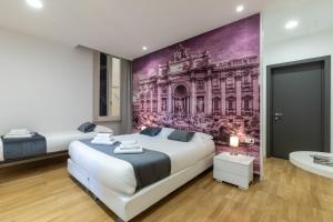 罗马罗马特雷维精英旅馆的一间卧室设有两张床,墙上挂着一幅画
