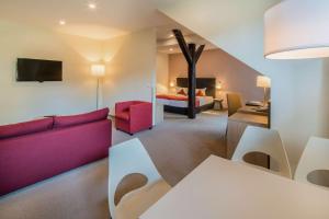 奎德林堡斯劳思穆勒奎德林堡贝斯特韦斯特酒店的一间带红色沙发的客厅和一间卧室