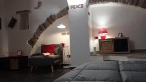 圣雷莫ROSEROSSE casa vacanze的一间卧室配有一张床、一把椅子和电视。