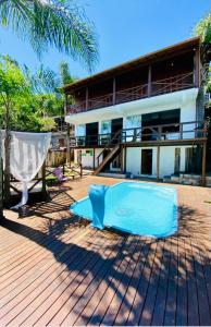 普腊亚罗萨Pousada Altos do Rei的房子前面有蓝色的游泳池的房子