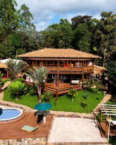 巴朗德科凯斯Estância Peti的一座大型木屋,前面设有一个游泳池