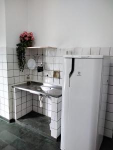 库亚巴Suíte 08 - Aconchegante e Exclusiva的一间带水槽和冰箱的小厨房