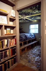 弗伦奇利克Lost River Hostel的一间设有书架的房间,里面设有一张床