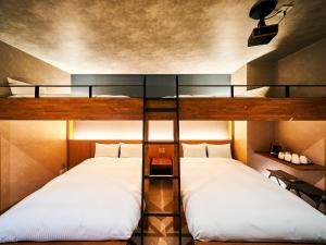 那霸Rakuten STAY Naha-Miebashi Bunk bed Room的带高架床的客房内的两张床