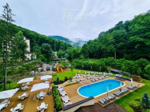 克利默内什蒂Hotel IZVOARE Caciulata的享有带游泳池的度假村的空中景致