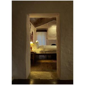 阿尔莫拉Mulberry House的卧室配有一张床铺,位于带开放式门廊的房间