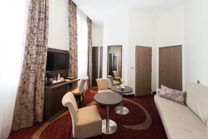 科涅克科涅克中心弗朗索瓦普瑞米尔酒店的客厅配有沙发和桌子